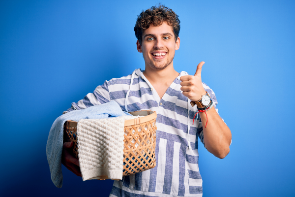 Guy With Laundry Basket Giving Thumbs Up Blue Background 600X400