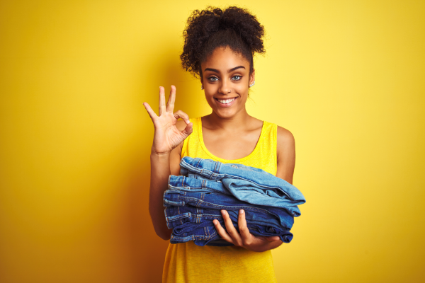Girl With Laundry Basket Holding Jeans Okay Sign 600X400